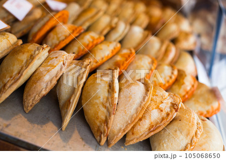 Freshly baked empanadas with different fillings for sale 105068650
