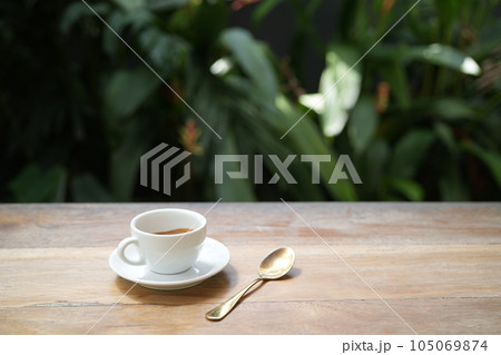 White coffee cup on wooden table with notebooks on wooden table 105069874
