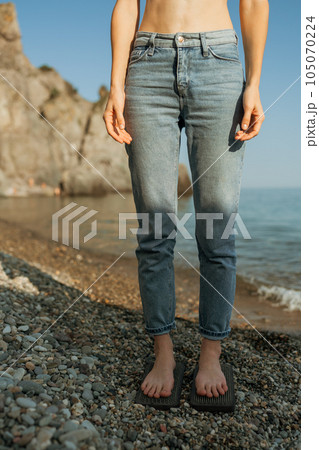 Sea Woman feet stepping on sadhu board during indian practice on the seashore. . Healthy lifestyle concept. tool for working out your inner state Sea Woman feet stepping on sadhu board during indian practice on the seashore. . Healthy lifestyle concept. tool for working out your inner state 105070224