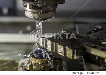 Closeup scene the wire EDM machine cutting the mold insert parts. Closeup scene the wire EDM machine cutting the mold insert parts. 105070492