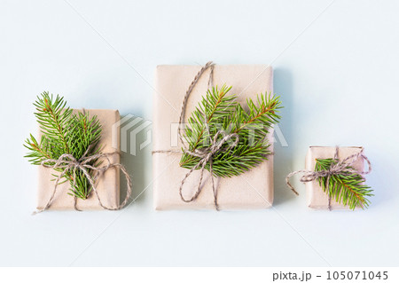Christmas composition of a gift boxes with Christmas tree branches. Concept of New year and Christmas, flat lay Christmas composition of a gift boxes with Christmas tree branches. Concept of New year and Christmas, flat lay 105071045