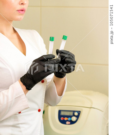 osmetologist holds test tube with blood osmetologist holds test tube with blood 105071541
