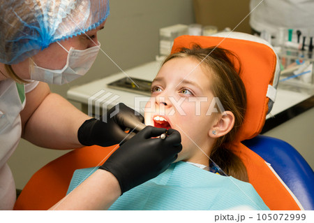 Girl on dental appointment. Regular check up teeth 105072999