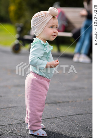 Toddler girl walking on children playground in city park Toddler girl walking on children playground in city park 105073279