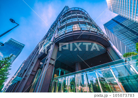 日本の東京都市景観 7月。猛暑…東京・丸の内のオフィス街や新丸ビルのガラス窓に映る東京駅などを望む 105073783