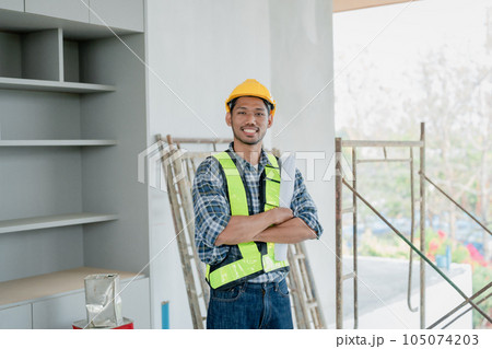 multi ethnic engineer brainstorming and measuring for cost estimating on paperworks and floor plan drawings about design architectural and engineering for houses and buildings. 105074203