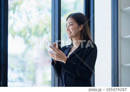 Asian businesswoman in office happy and cheerful during using smartphone and working. Female employees express the excitement of success and bonuses Asian businesswoman in office happy and cheerful during using smartphone and working. Female employees express the excitement of success and bonuses 105074287