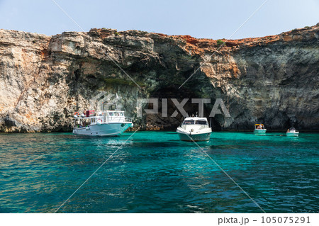 Boats sails the Blue Lagoon of Comino, Malta Boats sails the Blue Lagoon of Comino, Malta 105075291