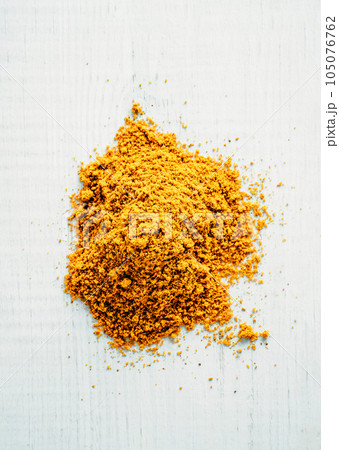 Heap of garam masala spice, white wood background 105076762