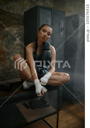 Female fighter with boxing taping bandage on her hands posing for camera 105076918