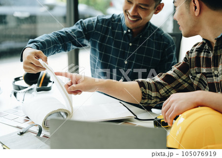 Engineers, designers and interior designers are finalizing the design of interiors by discussing selecting materials and colors to design rooms to present to clients 105076919