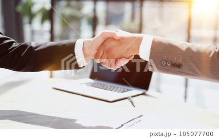 Business shaking hands, finishing up meeting. Successful businessmen handshaking after good deal. Business shaking hands, finishing up meeting. Successful businessmen handshaking after good deal. 105077700