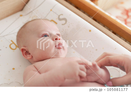 Photo of 3 months old infant baby boy, changing after bath, blurred mother hands in corner 105081177