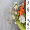 beautiful bright bouquet in a purple basket on a white background, copy space 105083247