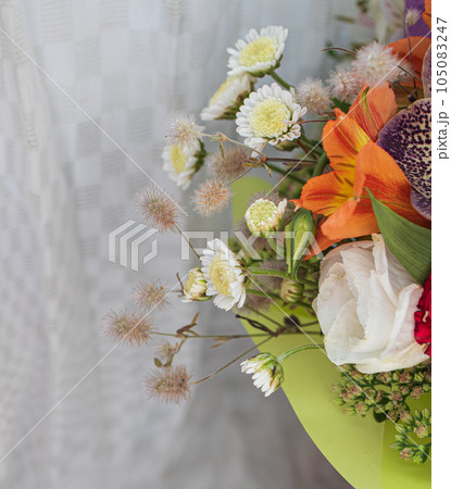 beautiful bright bouquet in a purple basket on a white background, copy space 105083247