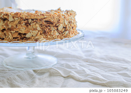 napoleon cake, round whole with caramel cream on a white background. copy space napoleon cake, round whole with caramel cream on a white background. copy space 105083249