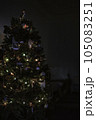 Decorated Christmas tree with lights on a dark background, copy space 105083251