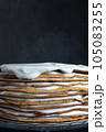 a whole round honey cake on a stand against a dark background 105083255