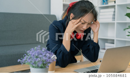 Asian student young woman stress while study on laptop, Asian young woman had headache while study 105084681