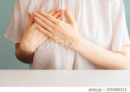 胸に手をあてる女性 105088313