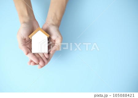 Property, house insurance protection concept. wood model house in hands. house care. Property, house insurance protection concept. wood model house in hands. house care. 105088421