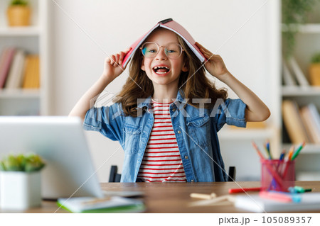 Girl doing homework or online education. 105089357