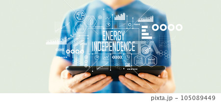 Energy Independence concept with man using a tablet Energy Independence concept with man using a tablet 105089449