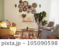 part of boho style living room with wooden coffee table and yellow sofa. cozy apartment decorated with plants. 105090598
