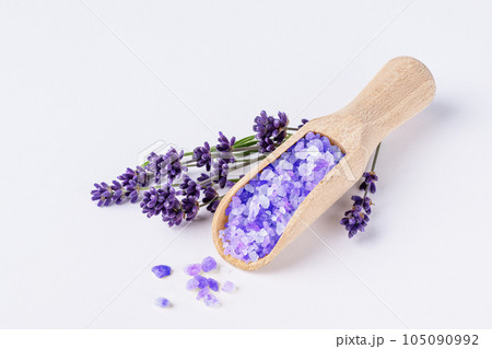 Lavender bath salt with lavender flowers on white background. Lavender herbal sea salt for spa aromatherapy and body care. Lavender bath salt with lavender flowers on white background. Lavender herbal sea salt for spa aromatherapy and body care. 105090992