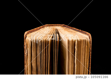 ancient book shot on black background 105091166