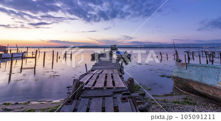 a wooden pier and boats 105091211