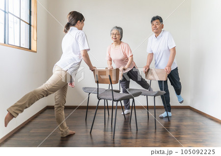 介護施設で椅子体操・運動・リハビリするシニア・高齢者の男女と理学療法士・介護士・トレーナー（脚） 105092225