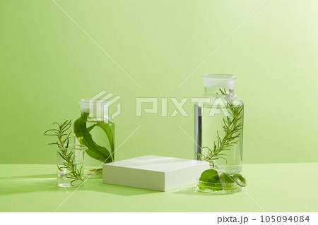 Empty podium decorated with transparent jars, a beaker and petri dish filled with types of seaweed. Seaweed helping to smooth out wrinkles Empty podium decorated with transparent jars, a beaker and petri dish filled with types of seaweed. Seaweed helping to smooth out wrinkles 105094084