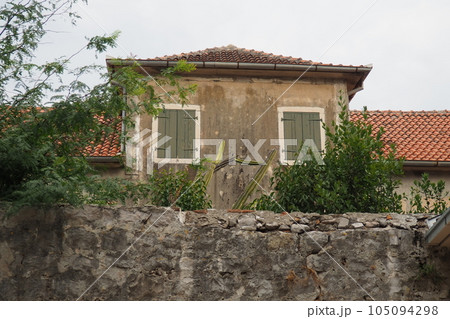 Herceg Novi, Montenegro, August 9, 2022. Architecture of the Adriatic coast of the Mediterranean. Boka-Kotor Bay. Modern and historical buildings of the old city and residential areas. Narrow streets Herceg Novi, Montenegro, August 9, 2022. Architecture of the Adriatic coast of the Mediterranean. Boka-Kotor Bay. Modern and historical buildings of the old city and residential areas. Narrow streets 105094298