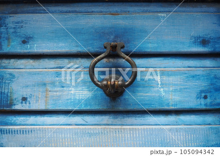 A door knocker is a fixture on the front door of a house. It is made of metal and has the form of a ring, is knocked on the metal part of the door knocker fixed to the wall. Herceg Novi, Montenegro A door knocker is a fixture on the front door of a house. It is made of metal and has the form of a ring, is knocked on the metal part of the door knocker fixed to the wall. Herceg Novi, Montenegro 105094342