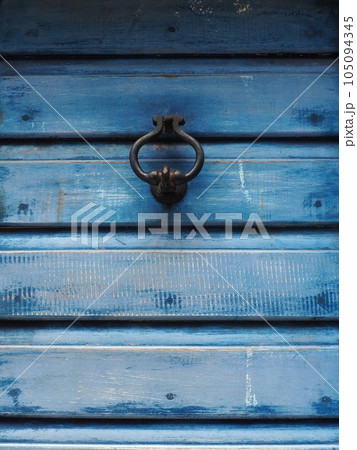 A door knocker is a fixture on the front door of a house. It is made of metal and has the form of a ring, is knocked on the metal part of the door knocker fixed to the wall. Herceg Novi, Montenegro A door knocker is a fixture on the front door of a house. It is made of metal and has the form of a ring, is knocked on the metal part of the door knocker fixed to the wall. Herceg Novi, Montenegro 105094345