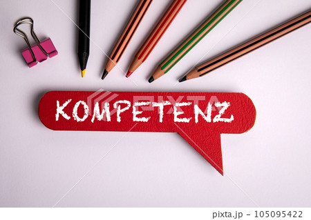 Competence Concept. Text on red speech bubble in german language. Office desk Competence Concept. Text on red speech bubble in german language. Office desk 105095422