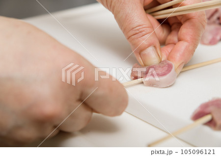 【焼き鳥豚タンの串打ちをする主婦】 105096121