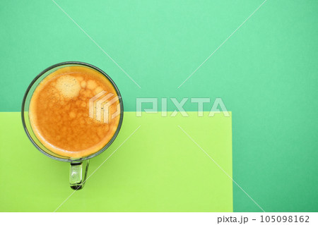 glass of hot black coffee put on green background glass of hot black coffee put on green background 105098162