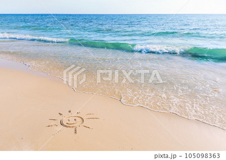 The drawing of the sun on sand beach with soft waves The drawing of the sun on sand beach with soft waves 105098363