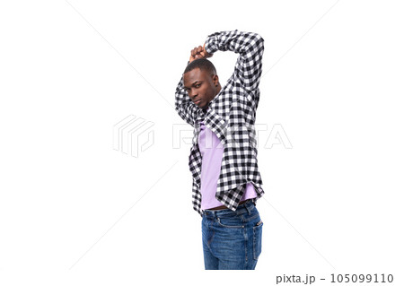 portrait of attractive dark skinned man in plaid shirt and jeans posing over isolated white 105099110