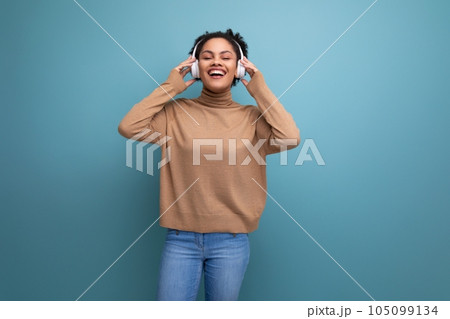 isolated background, cute young brunette hispanic woman freelancer listening to music in bluetooth isolated background, cute young brunette hispanic woman freelancer listening to music in bluetooth 105099134
