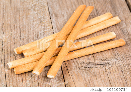 bread sticks grissini on wooden background 105100754