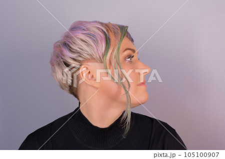 Portrait in profile of a stylish adult cute Caucasian woman with a bob hairstyle, color coloring on a studio background Portrait in profile of a stylish adult cute Caucasian woman with a bob hairstyle, color coloring on a studio background 105100907