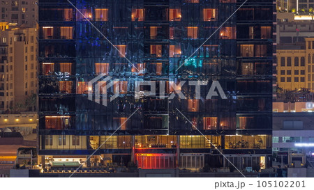 Office and residential buildings windows illuminated at night timelapse 105102201