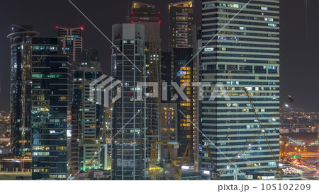 Cityscape with skyscrapers of Dubai Business Bay and water canal aerial night timelapse. 105102209