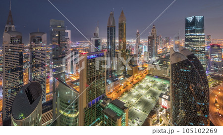 Skyline view of the high-rise buildings on Sheikh Zayed Road in Dubai aerial night to day timelapse, UAE. 105102269