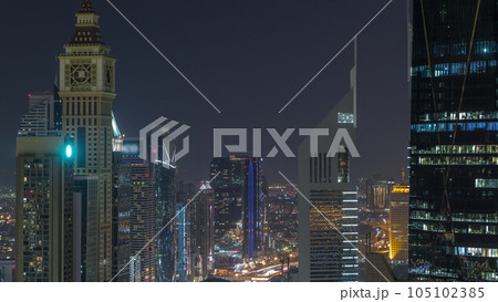 Skyline view of the high-rise buildings on Sheikh Zayed Road in Dubai aerial night timelapse, UAE. 105102385