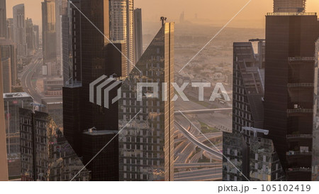 High-rise buildings on Sheikh Zayed Road in Dubai aerial timelapse during sunset, UAE. 105102419
