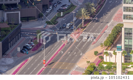 Aerial view from above to a busy road intersection in Dubai timelapse. 105102431